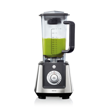 A transparent POWER FUEL GLASS JUG with a black handle, marked with measurement units, is shown with a lid and a small grey knife attachment hovering above it. The glass flask is empty and the components are visibly separated.