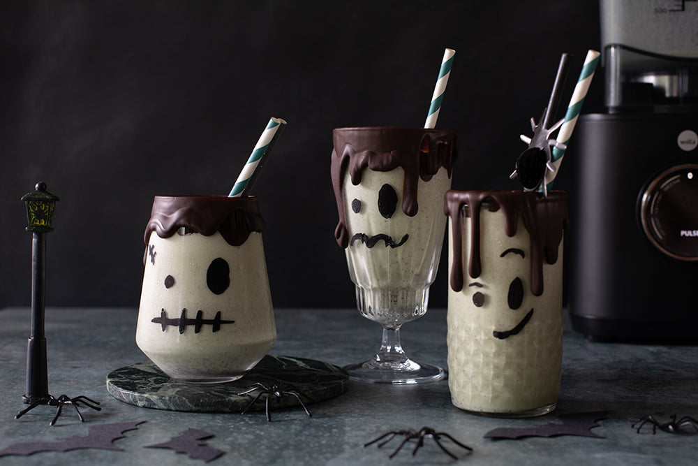 Pistachio milkshakes in glasses with chocolate Frankenstein faces for Halloween