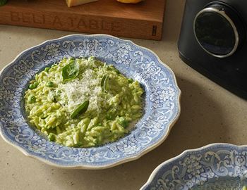 Plate of green pea and lemon orzo topped with grated Parmesan