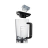 Se muestra una JARRA DE CRISTAL POWER FUEL transparente con asa negra, marcada con unidades de medida, junto con una tapa y un pequeño accesorio en forma de cuchillo gris suspendido sobre ella. La jarra de cristal está vacía y los componentes se ven claramente separados.