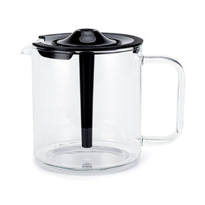 A clear glass pitcher with a black plastic lid and handle. The PERFORMANCE COMPACT COFFEE JUG W/LID, ideal for holding up to 10 cups, features a spout for pouring and a central black infuser tube extending from the lid into the body of the pitcher. The design is modern and minimalist.
